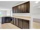 Kitchen featuring dark wood cabinets and stainless steel appliances at 724 Lake Cummings Blvd, Lake Alfred, FL 33850