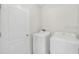 Bright laundry room with neutral walls with modern washing machine and dryer at 724 Lake Cummings Blvd, Lake Alfred, FL 33850