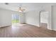 Spacious living room with wood flooring and sliding glass door to the backyard at 724 Lake Cummings Blvd, Lake Alfred, FL 33850