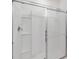 This is a bathroom shower with sliding glass doors and a built in shelf for storage of shampoo, conditioner, and body wash at 724 Lake Cummings Blvd, Lake Alfred, FL 33850