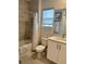 Clean and modern bathroom featuring a bathtub, shower, white vanity, and neutral tiling at 755 Driving Range Ct, Reunion, FL 34747