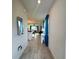 Inviting hallway with wood-look tile flooring leading to an open-concept living space at 755 Driving Range Ct, Reunion, FL 34747