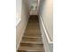 Staircase with wood treads and white risers leading to the upper level at 755 Driving Range Ct, Reunion, FL 34747