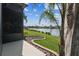 Beautiful backyard view with lush landscaping and serene lake, perfect for relaxation at 759 Glendora Rd, Poinciana, FL 34759