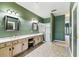 Bathroom featuring a double vanity, shower, and tile floors at 759 Glendora Rd, Poinciana, FL 34759