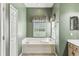 Bathroom featuring a garden tub, window and tile floors at 759 Glendora Rd, Poinciana, FL 34759