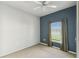 Carpeted bedroom with a ceiling fan and window overlooking the backyard at 759 Glendora Rd, Poinciana, FL 34759