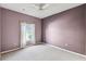 Neutral carpeted bedroom with a window providing natural light and ceiling fan at 759 Glendora Rd, Poinciana, FL 34759