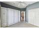 Bedroom with built-in cabinets, carpet and ceiling fan at 759 Glendora Rd, Poinciana, FL 34759