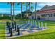 Outdoor oversized chess board on a manicured lawn, framed by palm trees and benches, creating a recreational space at 759 Glendora Rd, Poinciana, FL 34759