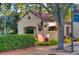 Charming community building with a red tile roof, arched entryway, and verdant landscaping at 759 Glendora Rd, Poinciana, FL 34759
