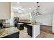 Kitchen with granite counters, dark cabinets, and a stylish island at 759 Glendora Rd, Poinciana, FL 34759