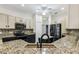 Close-up of the granite counters and stainless appliances in this well-lit kitchen at 759 Glendora Rd, Poinciana, FL 34759