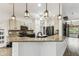 Bright kitchen with granite counters, stainless appliances, and decorative pendant lighting at 759 Glendora Rd, Poinciana, FL 34759