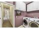 Functional laundry area with modern appliances, storage and access to hallway at 759 Glendora Rd, Poinciana, FL 34759
