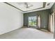 Spacious carpeted main bedroom with a trey ceiling, ceiling fan and a large window with backyard views at 759 Glendora Rd, Poinciana, FL 34759