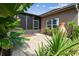 Charming patio area surrounded by lush tropical plants, offering a private outdoor space at 759 Glendora Rd, Poinciana, FL 34759