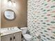 Cute powder room with vanity and toilet. Unique fish wallpaper at 759 Glendora Rd, Poinciana, FL 34759