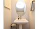 Pedestal sink and oval mirror in a well-lit bathroom at 932 Wild Date Ln, Lake Mary, FL 32746