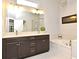Well-lit bathroom featuring a double sink vanity, soaking tub, and glass-enclosed shower at 932 Wild Date Ln, Lake Mary, FL 32746
