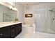Elegant bathroom with a double sink vanity, soaking tub, and glass-enclosed shower at 932 Wild Date Ln, Lake Mary, FL 32746