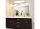 Beautiful bathroom with a dual vanity, quartz countertop, and modern lighting at 932 Wild Date Ln, Lake Mary, FL 32746