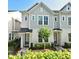 Charming two-story townhome with gray siding, manicured landscaping, and a welcoming front entrance at 932 Wild Date Ln, Lake Mary, FL 32746