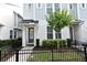 Charming townhome featuring gray siding, a cozy front porch, and a black wrought iron fence at 932 Wild Date Ln, Lake Mary, FL 32746