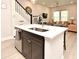 Open floor plan with an island featuring a stainless steel sink, and an attached dining and living area at 932 Wild Date Ln, Lake Mary, FL 32746