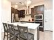 Modern kitchen with dark cabinets, a large island, stainless steel appliances, and pendant lighting at 932 Wild Date Ln, Lake Mary, FL 32746