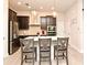 Stylish kitchen with a central island, dark cabinetry, and stainless steel appliances at 932 Wild Date Ln, Lake Mary, FL 32746
