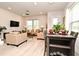 Open-concept living and dining area with modern furniture, natural light, and stylish decor at 932 Wild Date Ln, Lake Mary, FL 32746