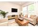 Bright living room featuring a comfortable sofa, modern furnishings, and natural light from large windows at 932 Wild Date Ln, Lake Mary, FL 32746