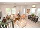 Comfortable living area with neutral furniture, large windows, and a dining area at 932 Wild Date Ln, Lake Mary, FL 32746