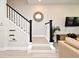 Elegant staircase with white risers, black handrail, and decor creating an inviting atmosphere at 932 Wild Date Ln, Lake Mary, FL 32746