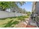 Fenced backyard featuring a well-maintained lawn, creating a private outdoor space at 98 Lakepointe Cir, Kissimmee, FL 34743
