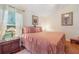 Cozy bedroom with hardwood floors, a plush bed, and a large window at 98 Lakepointe Cir, Kissimmee, FL 34743