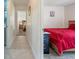 Hallway leading to a bedroom with neutral-toned walls and tile flooring at 98 Lakepointe Cir, Kissimmee, FL 34743
