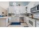Modern kitchen featuring white cabinets, stainless steel appliances, sleek countertops, and a stylish backsplash at 98 Lakepointe Cir, Kissimmee, FL 34743