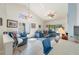 Bright living room featuring vaulted ceilings, skylight, tile flooring, and comfortable seating at 98 Lakepointe Cir, Kissimmee, FL 34743