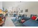 Bright living room boasts high ceilings, tile flooring, comfortable seating, and an open layout, perfect for relaxation at 98 Lakepointe Cir, Kissimmee, FL 34743