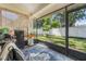 Enclosed porch overlooking green yard with a privacy fence at 98 Lakepointe Cir, Kissimmee, FL 34743