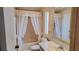 Neutral bathroom featuring a vanity, white toilet, and a bathtub with decorative curtains at 509 Tivoli Park Dr, Davenport, FL 33897