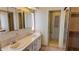 Bright bathroom featuring double sinks, a large vanity, a commode, and an open closet at 509 Tivoli Park Dr, Davenport, FL 33897