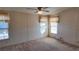Cozy bedroom with neutral walls, carpet flooring, and natural light from two windows at 509 Tivoli Park Dr, Davenport, FL 33897