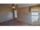 A bedroom featuring carpet, a ceiling fan, wallpaper and natural light at 509 Tivoli Park Dr, Davenport, FL 33897