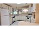Bright kitchen featuring white appliances, countertops, and ample cabinet space at 509 Tivoli Park Dr, Davenport, FL 33897