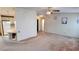 Open-concept living area with connecting kitchen, carpet flooring, and neutral walls at 509 Tivoli Park Dr, Davenport, FL 33897