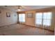 Bright living room featuring neutral carpet, ceiling fan, and large windows at 509 Tivoli Park Dr, Davenport, FL 33897