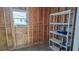 Inside of shed featuring exposed framing, shelving unit, and window with natural light at 509 Tivoli Park Dr, Davenport, FL 33897